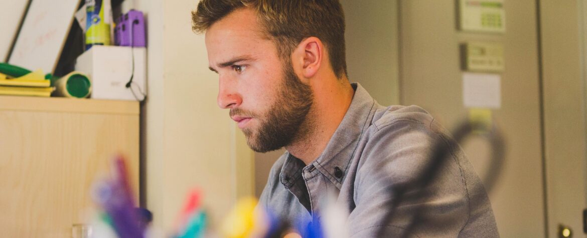 Photograph of a man concentrating while working.